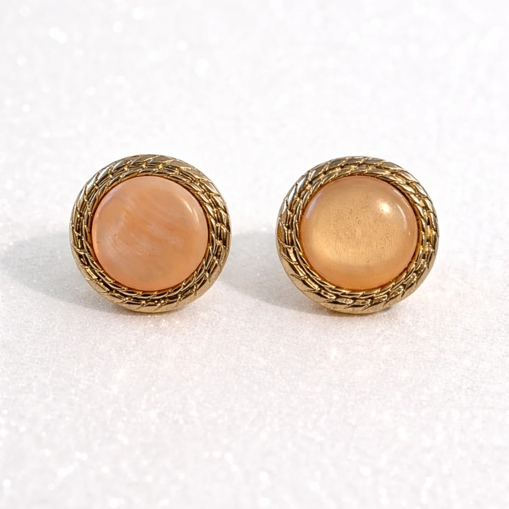 Vintage gold-tone clip-on earrings with pink moonglow cabochons.